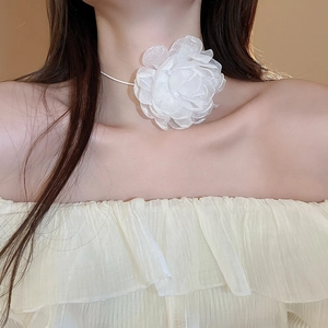 Close-up of white organza flower choker necklace on model showing delicate fabric petals