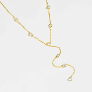 Macro shot of gold Y-shaped necklace with sparkling clear cubic zirconia stones
