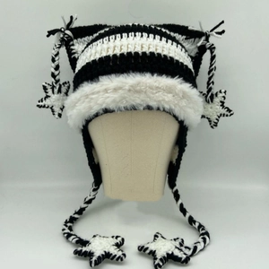 Striped knit cat ear hat with white plush trim and star pendants on beige model head