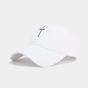 Detailed view of black linear PEACE letter embroidery on a white cotton baseball cap