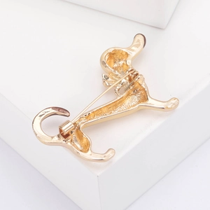 Detailed back view of golden dachshund brooch showing the safety pin fastener