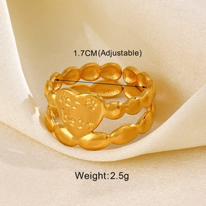 Detail of adjustable gold heart ring with 'For best' engraving on silk background