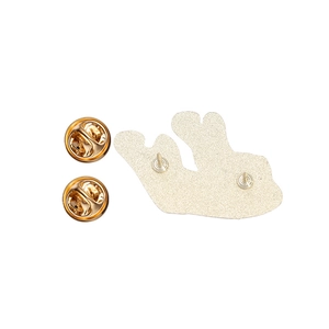 Detailed back view of gold tooth badge with dual pin needles and metal butterfly clasps