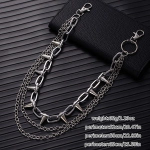 Close-up of silver punk multilayer wallet chain with spikes on black leather