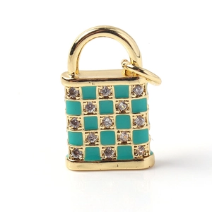 Macro shot of gold-plated lock pendant featuring green enamel and cubic zirconia stones