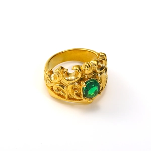 Detail of gold crown ring featuring an oval green gemstone with vintage filigree engraving