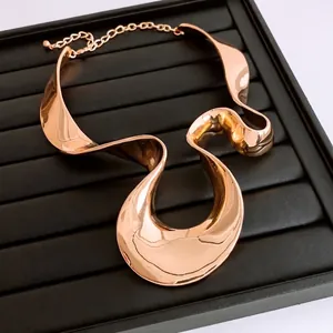 Exaggerated rose gold pleated metal collar necklace with abstract wavy sculptural design