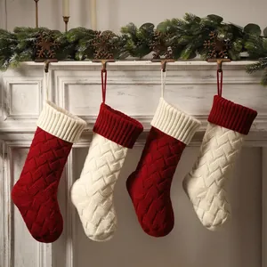 Large 18 inch cable knit Christmas stockings in red and cream on a white mantel