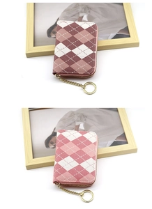Close-up of checkered accordion card wallet with fabric texture and gold key chain