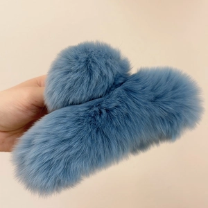 Detail of soft grey-blue faux rabbit fur hair claw clip with plush texture and matte finish