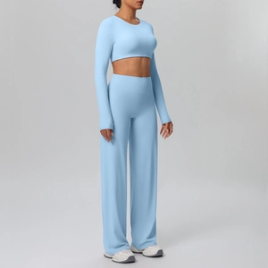 Women's light blue ribbed sports set featuring long sleeve crop top and wide leg pants
