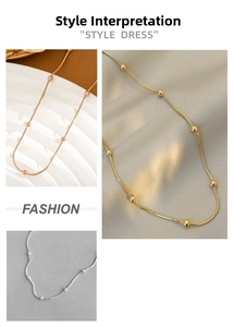 Detailed view of 18K gold-plated snake chain with polished metal beads in three colors