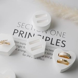 Minimalist white plaster jewelry display stand with geometric shapes and ring slots