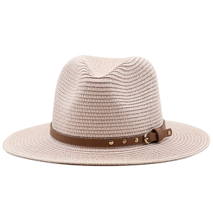Beige straw fedora sun hat with brown leather band and gold buckle on white background