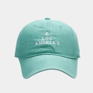 Close-up of mint green baseball cap featuring white embroidered A Los Angeles text detail