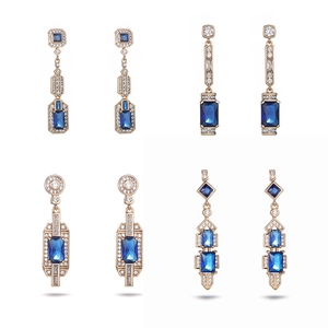 Luxurious gold earrings featuring geometric blue zircon stones and crystal accents