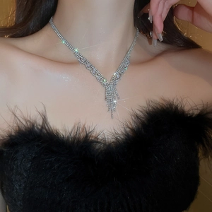 Close-up of sparkling zircon tassel necklace featuring a V-shaped vertical pendant design