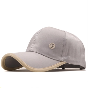 Stylish satin baseball cap with metallic M logo and contrasting beige brim piping