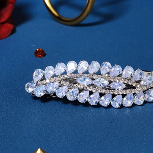 Macro shot of silver zircon hair clip featuring pear-cut stones in a leaf pattern