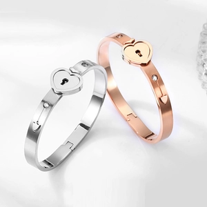 Detail of heart lock bracelets with crystal inlay in silver and rose gold finishes