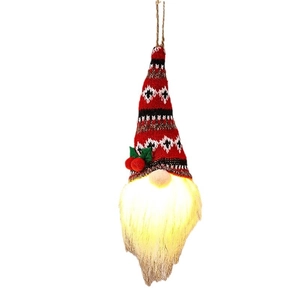 Hanging glowing Christmas gnome with red knitted hat and LED warm light on white background