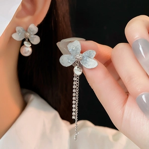 Detailed close-up of S925 hallmark on pearl and blue flower tassel earrings