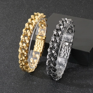 Detailed view of hammered texture vintage cuban link bracelets in gold and antique silver