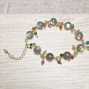 Detailed shot of labradorite beads with colorful gemstones and gold lobster clasp
