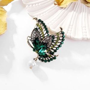 Vintage gold butterfly brooch with green crystals and hanging white pearl detail