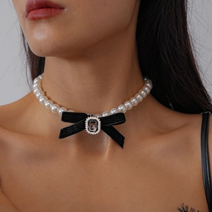 Detail of beaded pearl choker with black velvet bow and sparkling crystal pendant