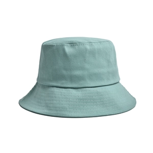 Close-up detail of the mint green bucket hat showing stitching and canvas texture