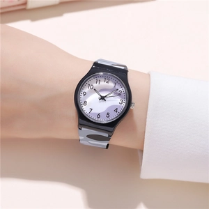 Close-up of a blue camouflage quartz watch on a wrist with a wavy purple dial design