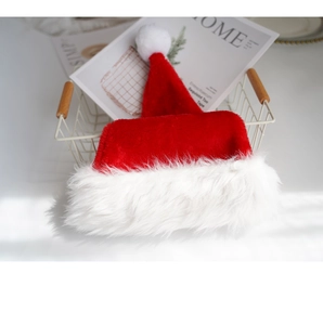 Classic red plush Christmas hat with soft white faux fur trim in a cozy basket