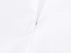 Macro shot of white invisible zipper on textured linen fabric of the two-piece set