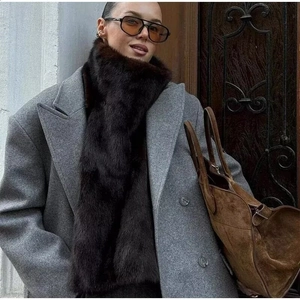 Deep brown faux fur long scarf paired with a grey wool coat for street fashion style