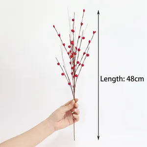 Detail of red artificial berry branch for Christmas decor measuring 48cm in length