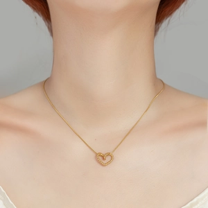 Elegant gold titanium steel necklace with a hollow woven heart pendant on a thin chain