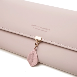 Close-up of pink PU leather wallet featuring leaf pendant and gold metal hardware clasp