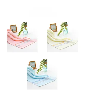 Detail of pure cotton towels in pink, yellow, and blue with checkered weave edges
