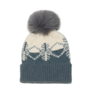 Detailed view of winter knit beanie with snowflake patterns and a soft gray faux fur pom-pom