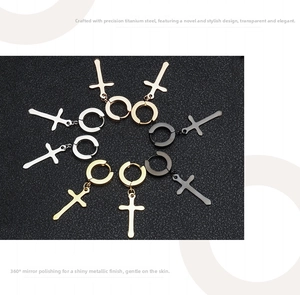 Detailed macro view of cross earrings set in silver, gold, and black polished steel