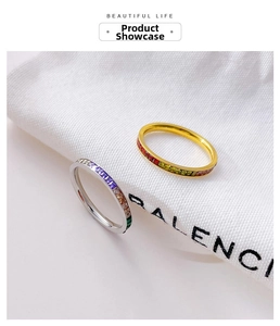 Detail of gold and silver stackable rings with colorful square-cut cubic zirconia stones