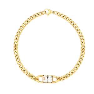 Macro detail of gold Cuban link chain necklace with a square clear zircon crystal pendant