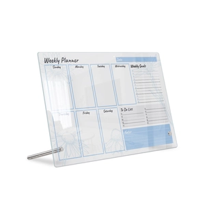 Macro shot of acrylic weekly planner featuring blue floral patterns and metal stand