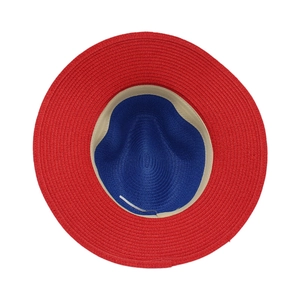 Detail view of the bi-color red and blue woven straw hat with high-quality interior sweatband