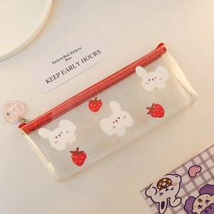 Detail of transparent glitter pencil case with red zipper and heart-shaped pendant charm