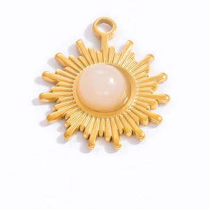 Macro detail of sunburst pendant with 18k gold plating and pink natural gemstone inlay