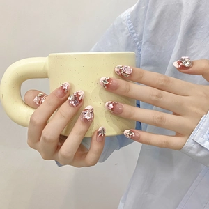 Handmade pink gradient press-on nails with luxury rhinestones and almond shape
