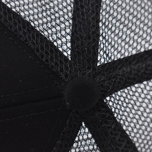 Detail view of reinforced crown stitching and breathable mesh panels on truck cap