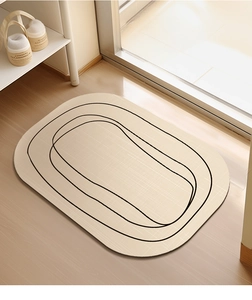 Macro detail of oval diatom mud mat with minimalist black lines on light wood floor